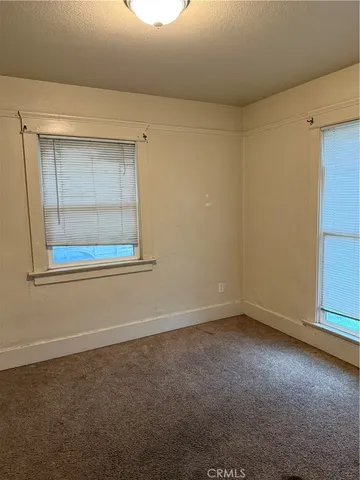 a view of an empty room with windows