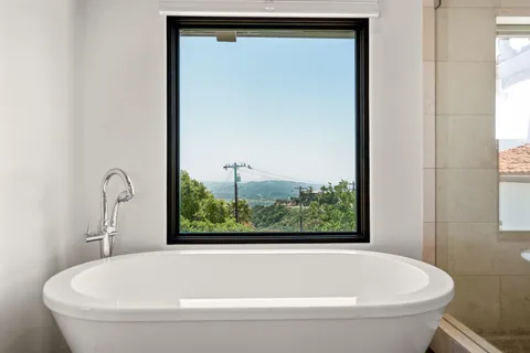 a bedroom with a large bed and a balcony view