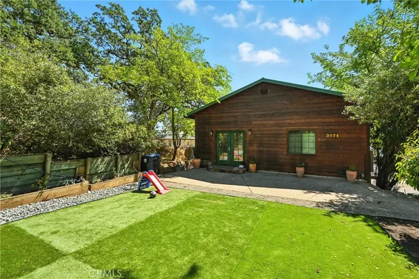 a view of a house with a backyard