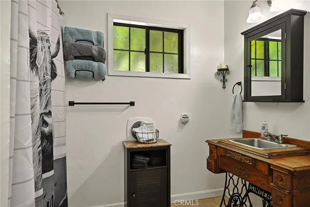 a bathroom with a sink and a window