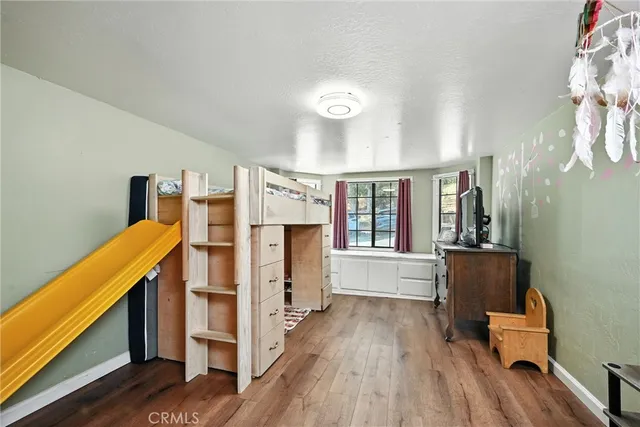 a view of a kitchen with furniture and wooden floor