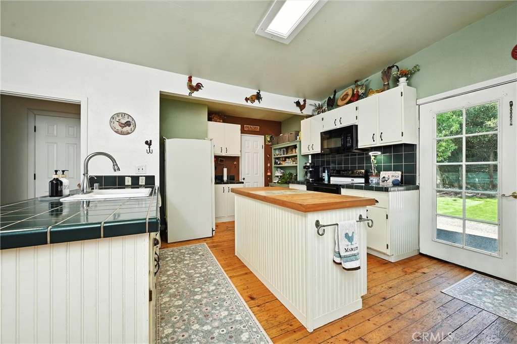 3171 Springe Street Nice, CA 95464 - Photo 3 of 28 a kitchen with stainless steel appliances granite countertop a stove a sink dishwasher and a refrigerator with wooden floor