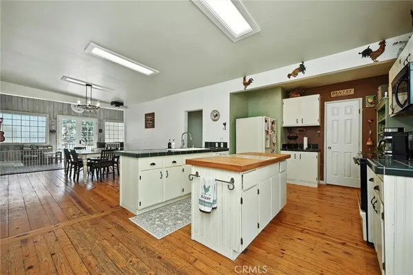a large white kitchen with a large window