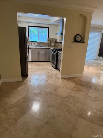 a large kitchen with a stove and a refrigerator
