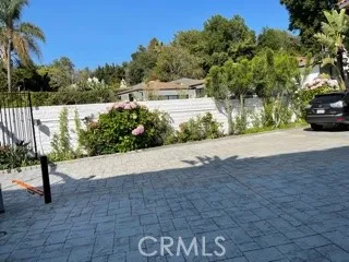 a view of a street with a bench in front of house