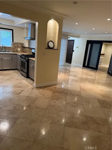 a kitchen with stainless steel appliances granite countertop a stove a sink and a refrigerator