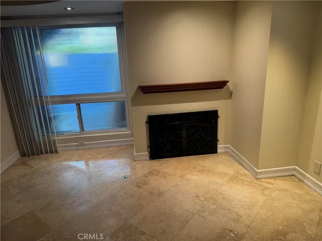 a view of an empty room with a fireplace