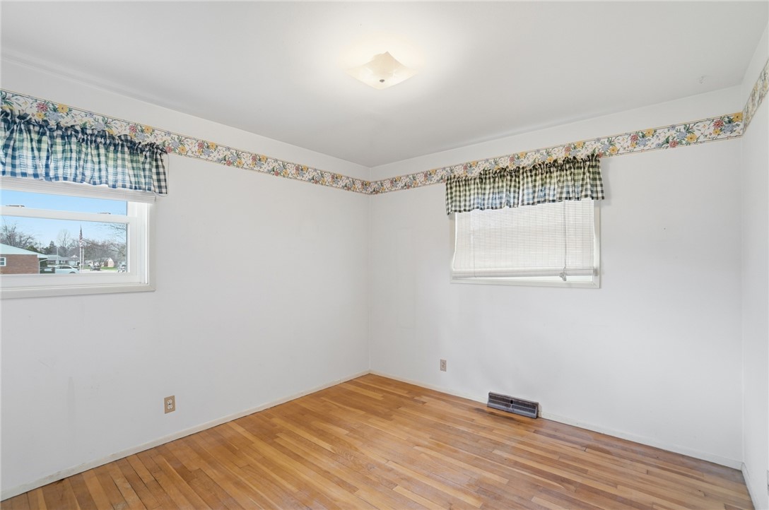 1087 Fairfield Road Troy, OH 45373 - Photo 17 of 39 This bright room features a clean design with hardwood flooring, offering a versatile space.