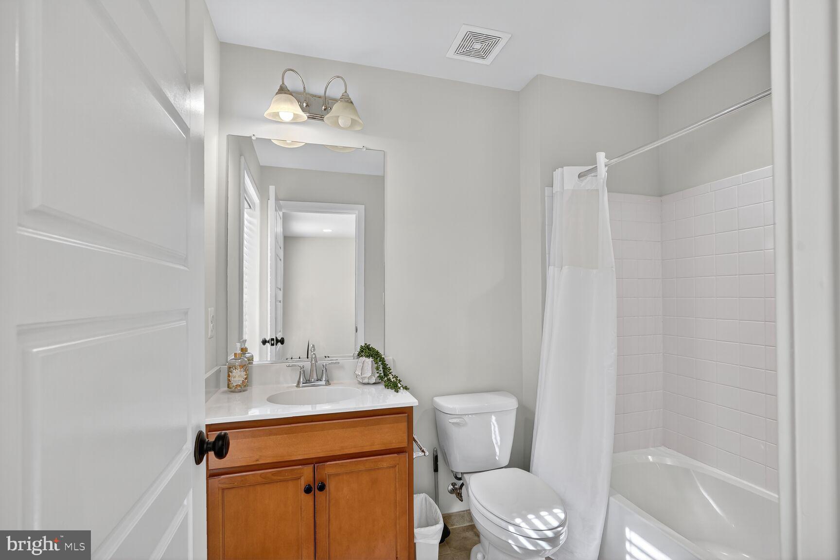 2373 Wyeth Street Silver Spring, MD 20906 - Photo 22 of 32 a bathroom with a toilet a sink and a mirror
