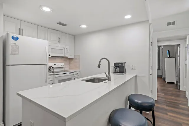 a kitchen with stainless steel appliances a refrigerator and a sink