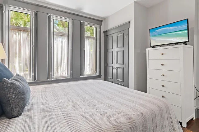 a bedroom with a bed and a flat screen tv