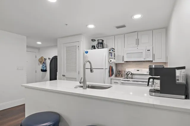 a kitchen with refrigerator and sink