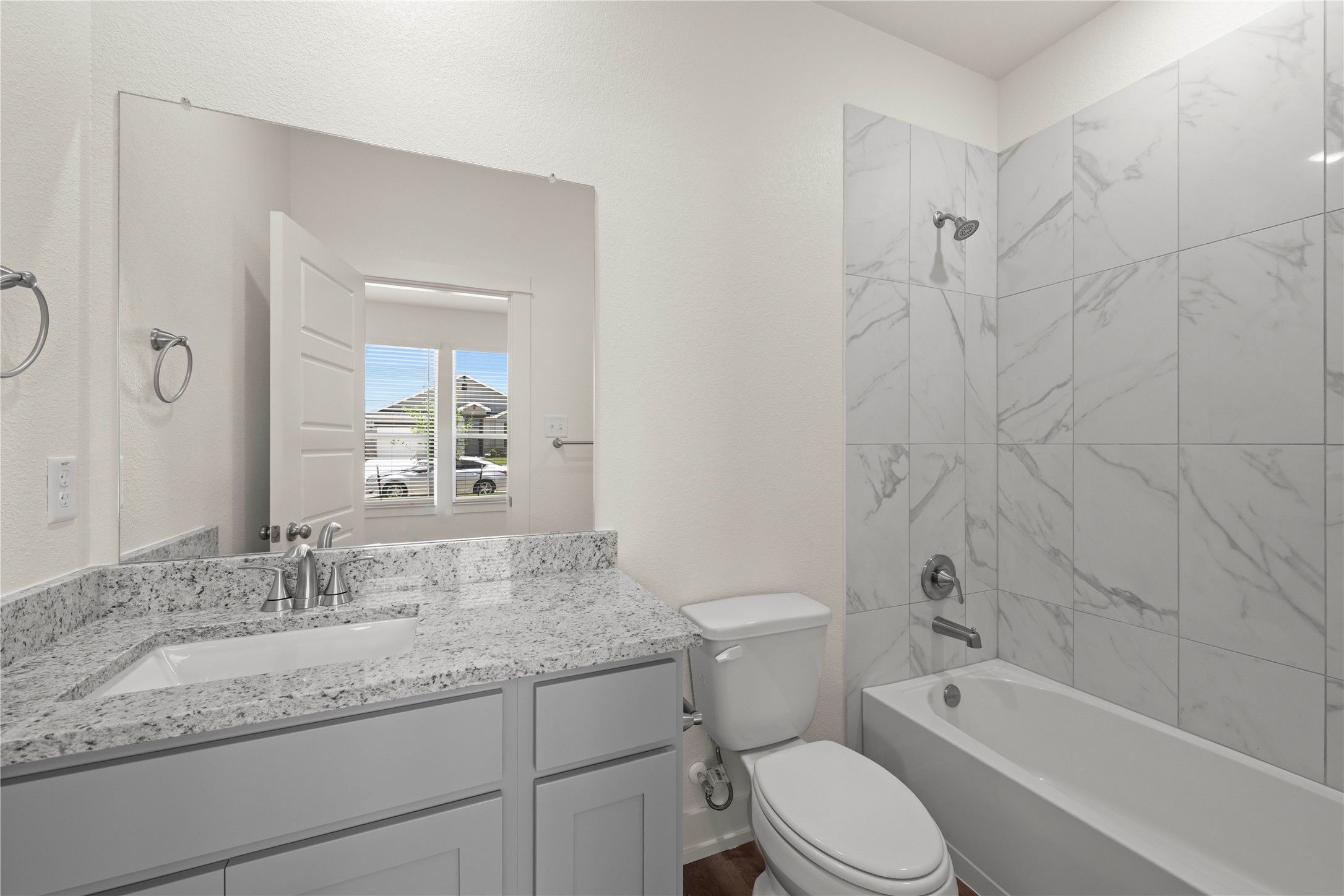 564 Gus Loop Georgetown, TX 78626 - Photo 18 of 32 a bathroom with a granite countertop toilet a sink and a bathtub