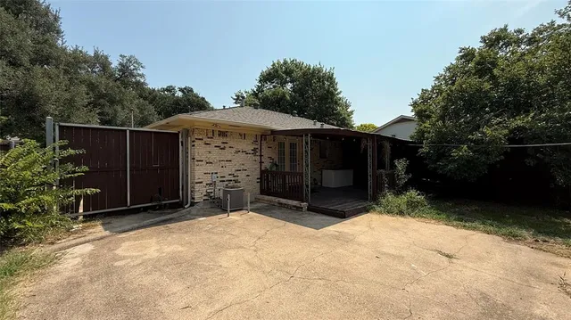 a wooden fence with some trees in the background