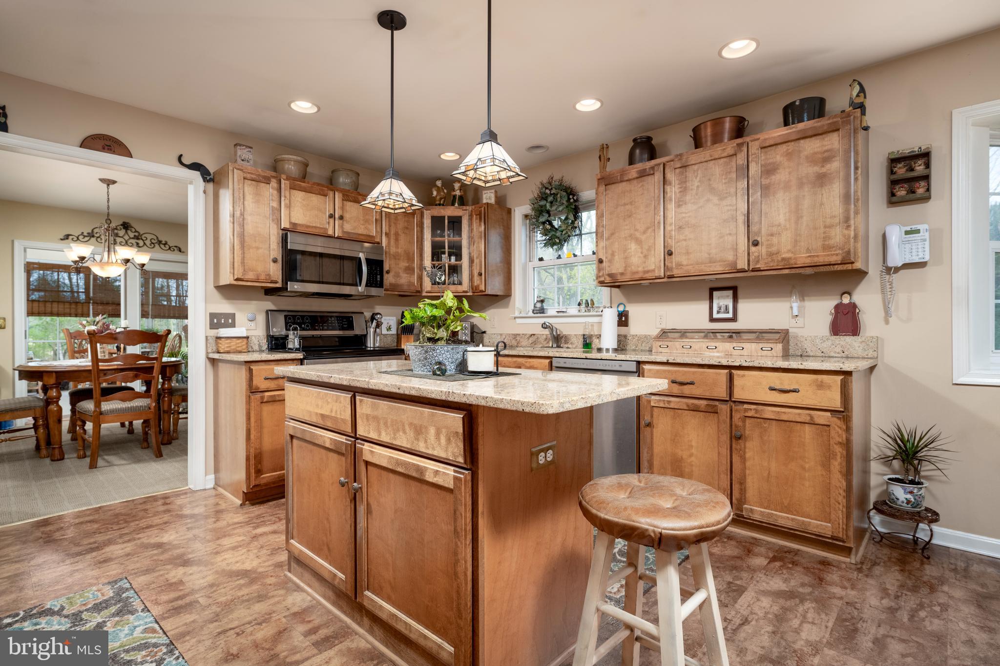 65 Susannah Drive Magnolia, DE 19962 - Photo 8 of 31 a kitchen with kitchen island granite countertop a sink cabinets and stainless steel appliances