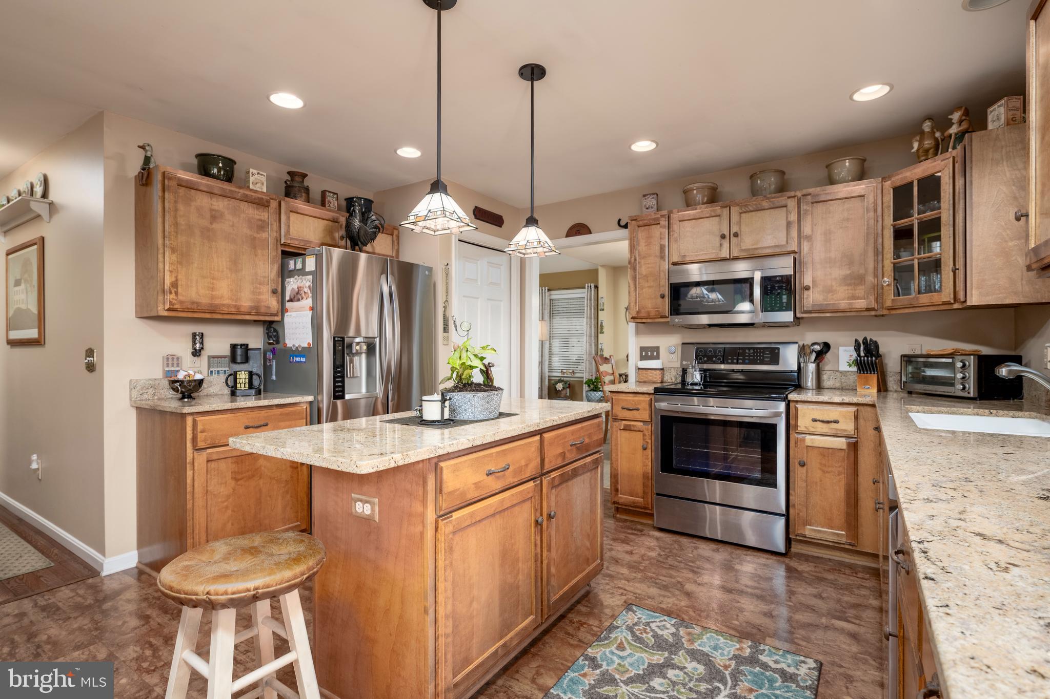 65 Susannah Drive Magnolia, DE 19962 - Photo 9 of 31 a kitchen with stainless steel appliances kitchen island granite countertop a sink stove and refrigerator