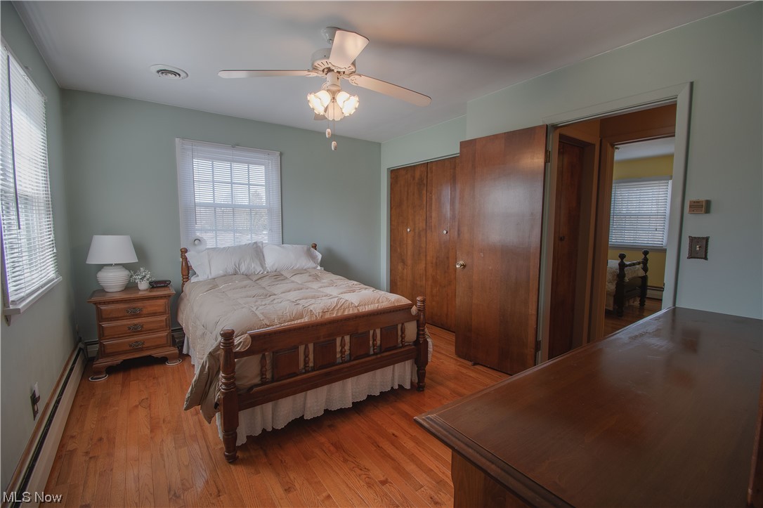 3142 Farmdale Road Akron, OH 44312 - Photo 12 of 22 Upstairs offers three bright bedrooms with stunning hardwood floors and another full-size bath with a large vanity, an oversized mirror, and tile floors.