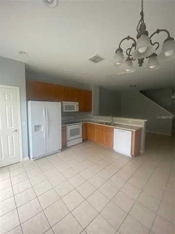a view of a kitchen with microwave and cabinets