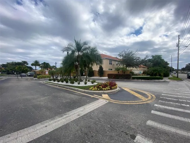 a view of a street with a cars parked in front of it