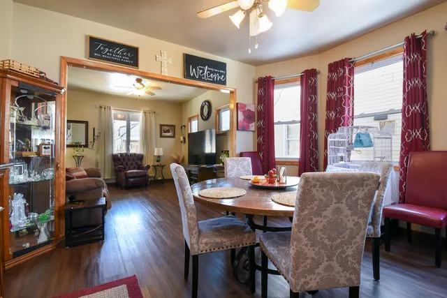 a view of a a dining room with furniture window and wooden floor
