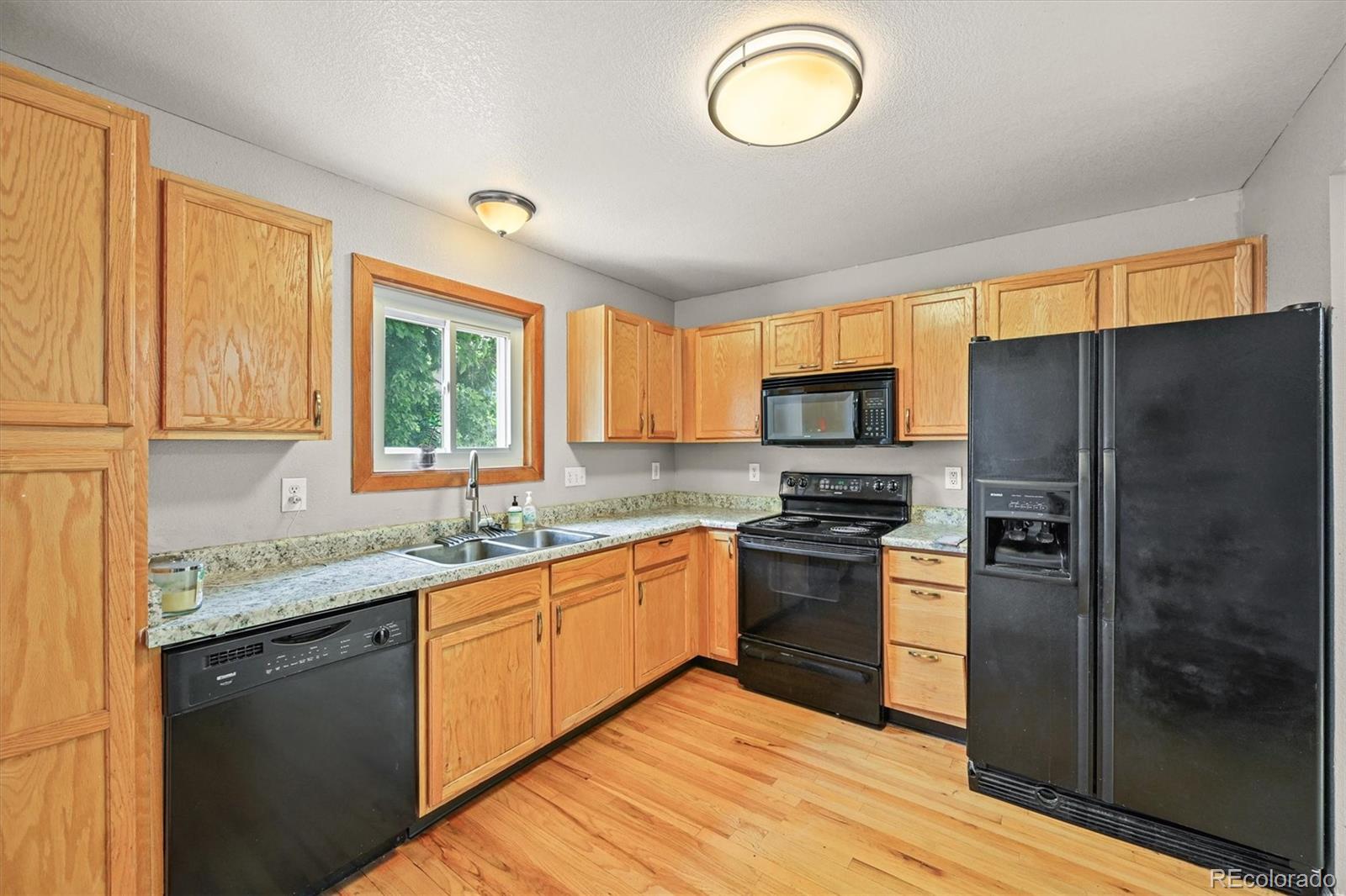 4452 Cornish Way Denver, CO 80239 - Photo 2 of 50 a kitchen with stainless steel appliances granite countertop a sink stove and refrigerator
