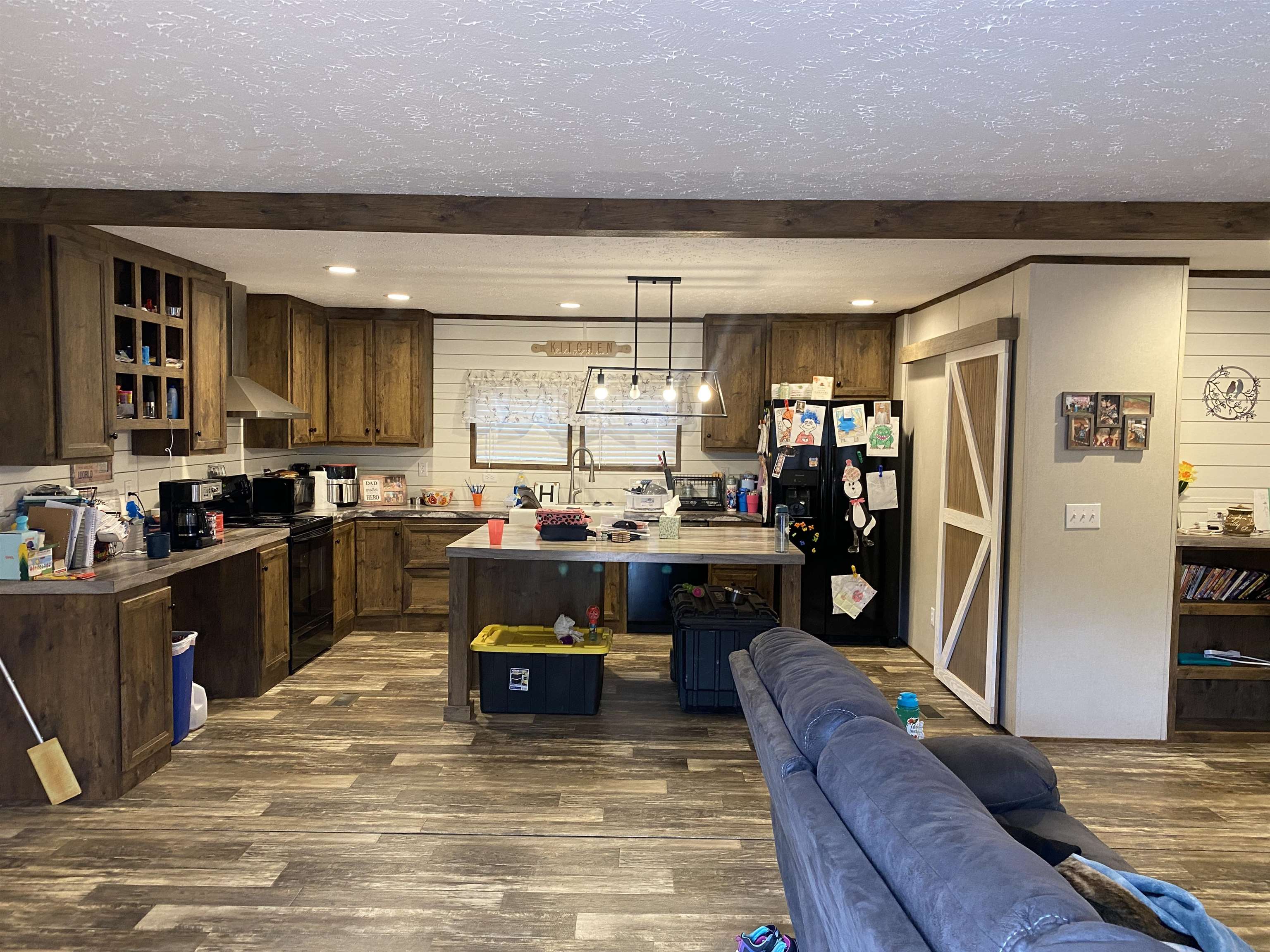 525 Sewell Bottom Road Adamsville, TN 38310 - Photo 11 of 37 a kitchen with stainless steel appliances kitchen island granite countertop a refrigerator a stove top oven and a sink with island