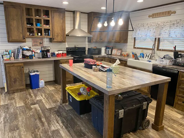 a kitchen with a stove a refrigerator and a sink