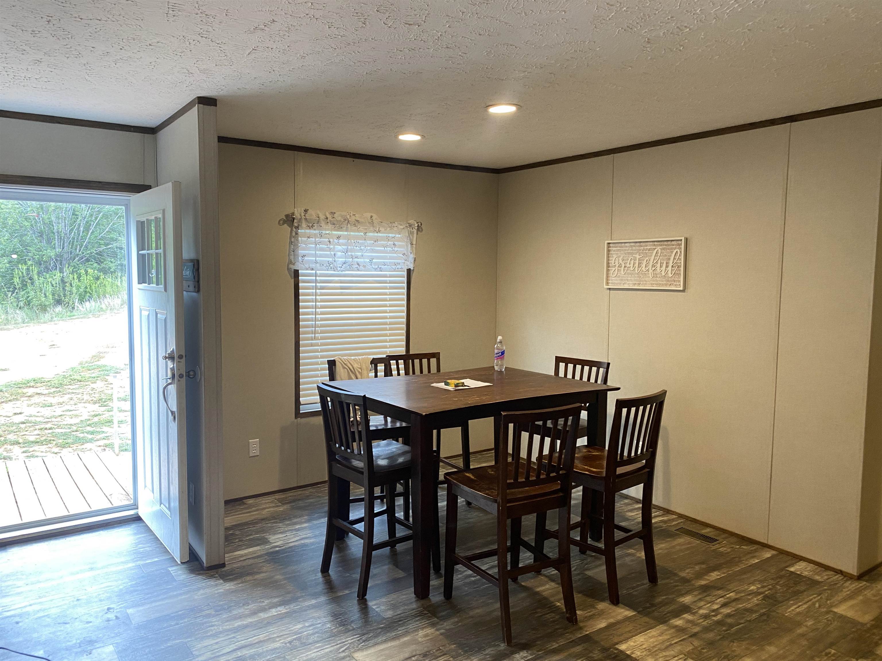 525 Sewell Bottom Road Adamsville, TN 38310 - Photo 16 of 37 a view of a dining room with furniture and wooden floor