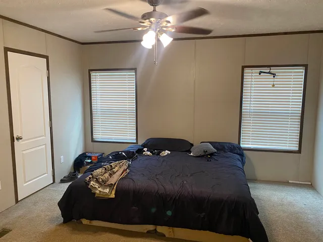 a bedroom with a bed and a window