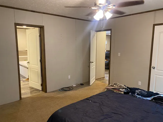 a bedroom with a bed and a chandelier