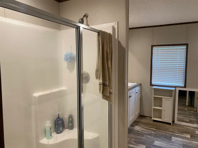 a bathroom with a shower and a sink