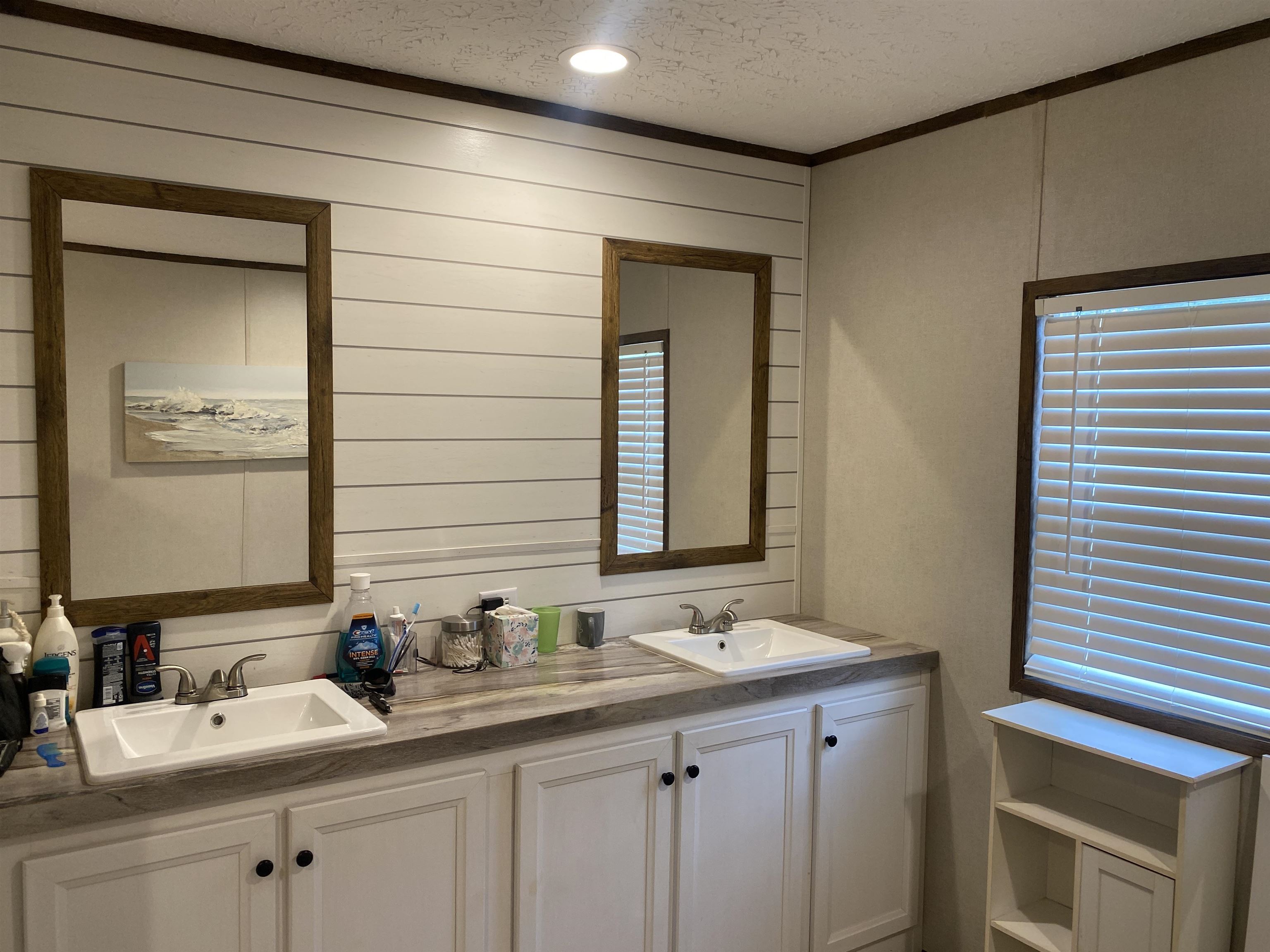 525 Sewell Bottom Road Adamsville, TN 38310 - Photo 21 of 37 a bathroom with 2 sink and a mirror