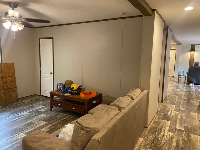 a living room with furniture and a chandelier