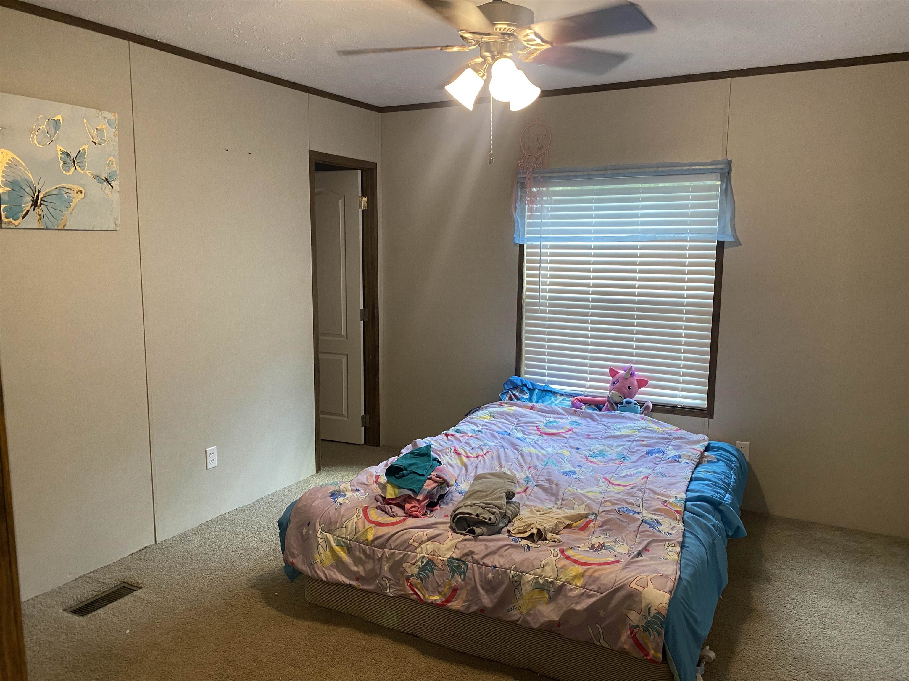 525 Sewell Bottom Road Adamsville, TN 38310 - Photo 24 of 37 a bedroom with a bed and a window