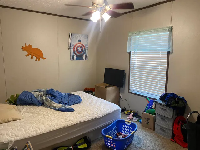 a bedroom with a bed and a chandelier