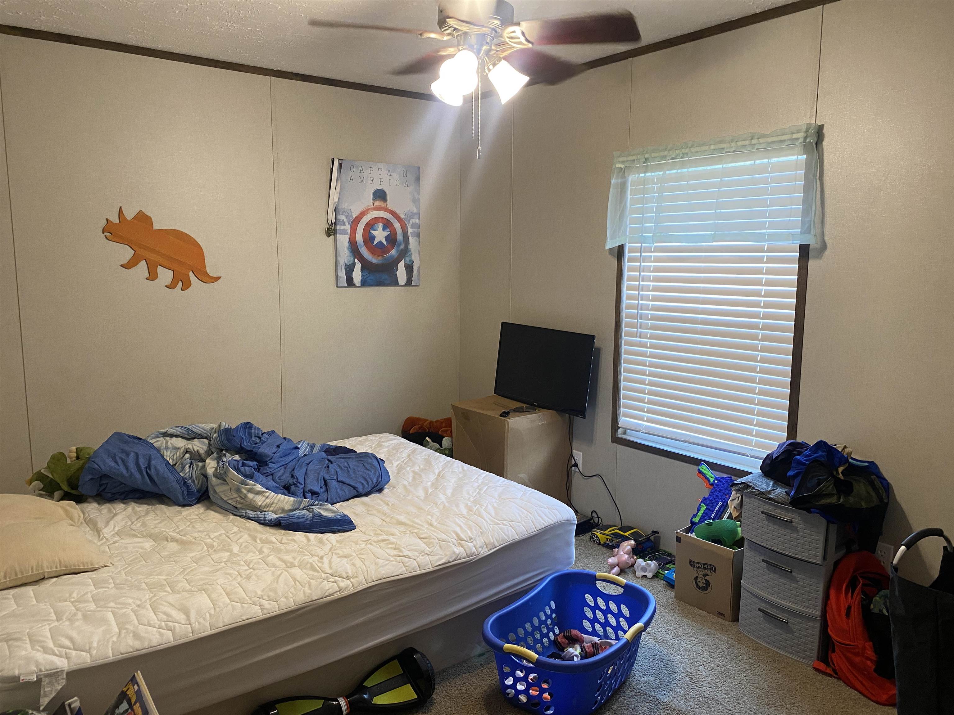 525 Sewell Bottom Road Adamsville, TN 38310 - Photo 25 of 37 a bedroom with a bed and a chandelier