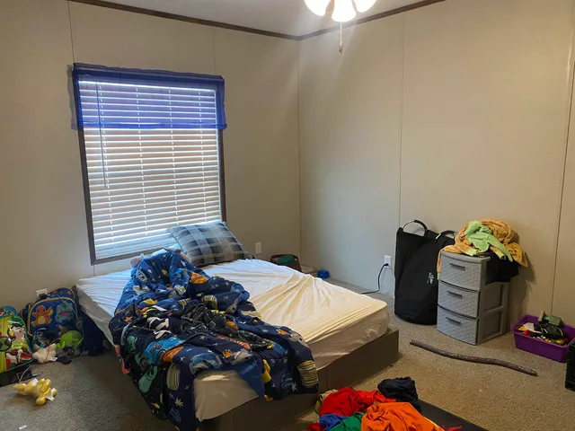 a bedroom with a bed and a chandelier