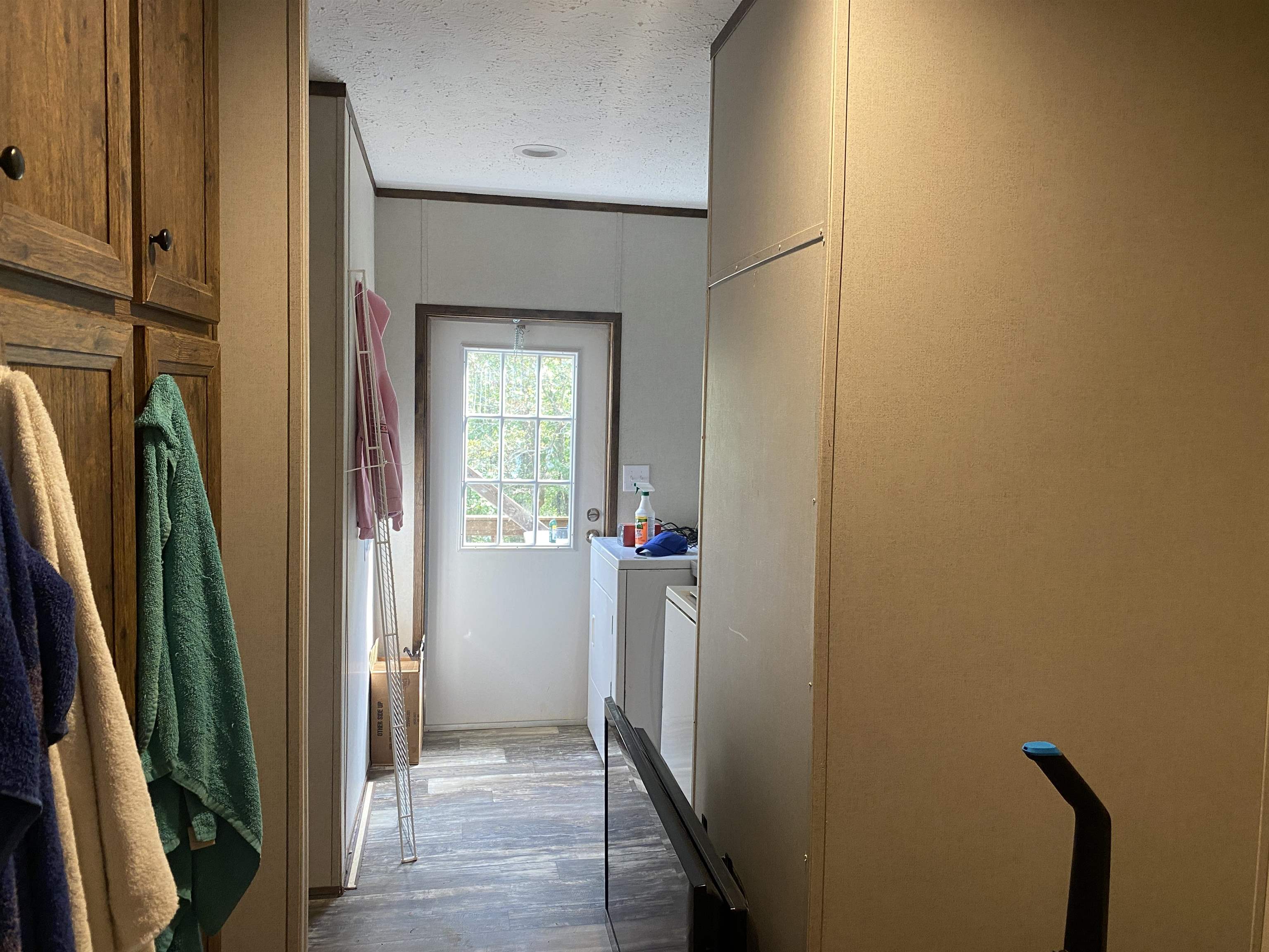 525 Sewell Bottom Road Adamsville, TN 38310 - Photo 28 of 37 a view of a hallway with wooden floor and stairs