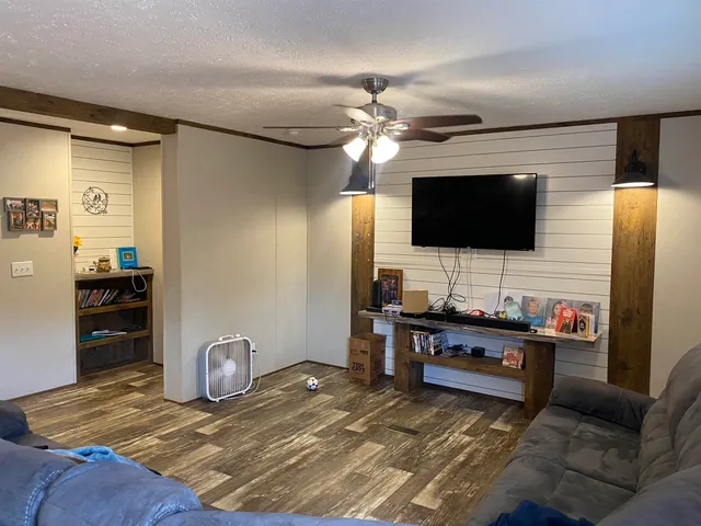 a living room with furniture and a flat screen tv