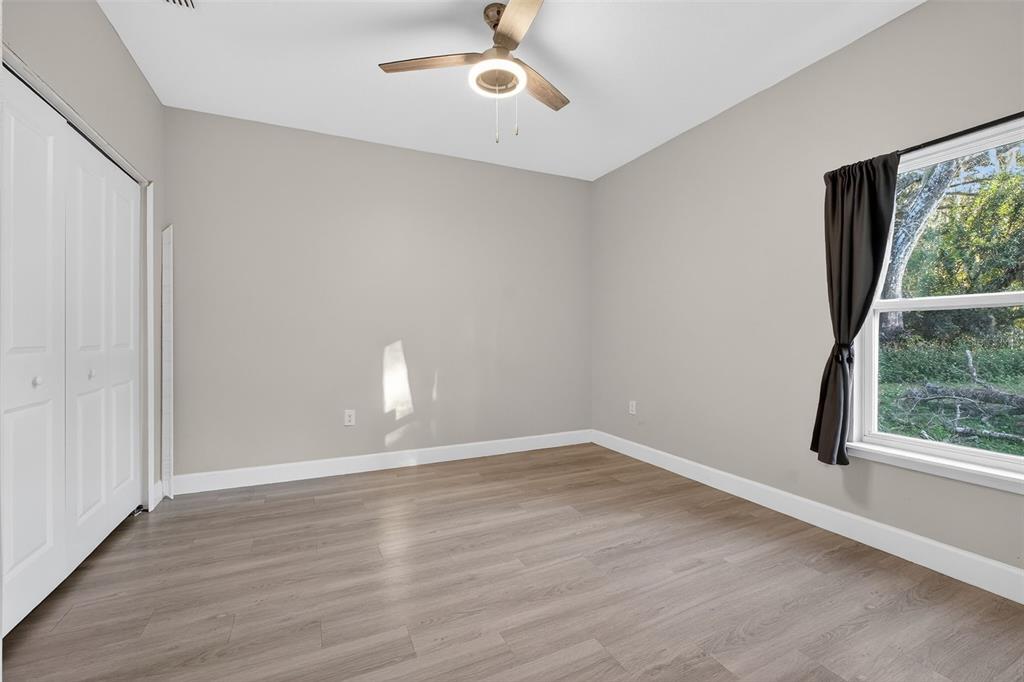 3633 Main Street Sanford, FL 32771 - Photo 13 of 31 a view of an empty room with wooden floor and a window