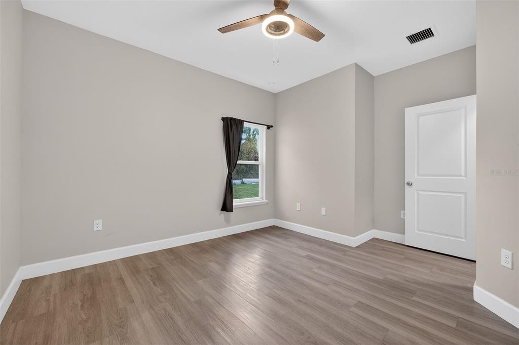 3633 Main Street Sanford, FL 32771 - Photo 14 of 31 an empty room with wooden floor and windows