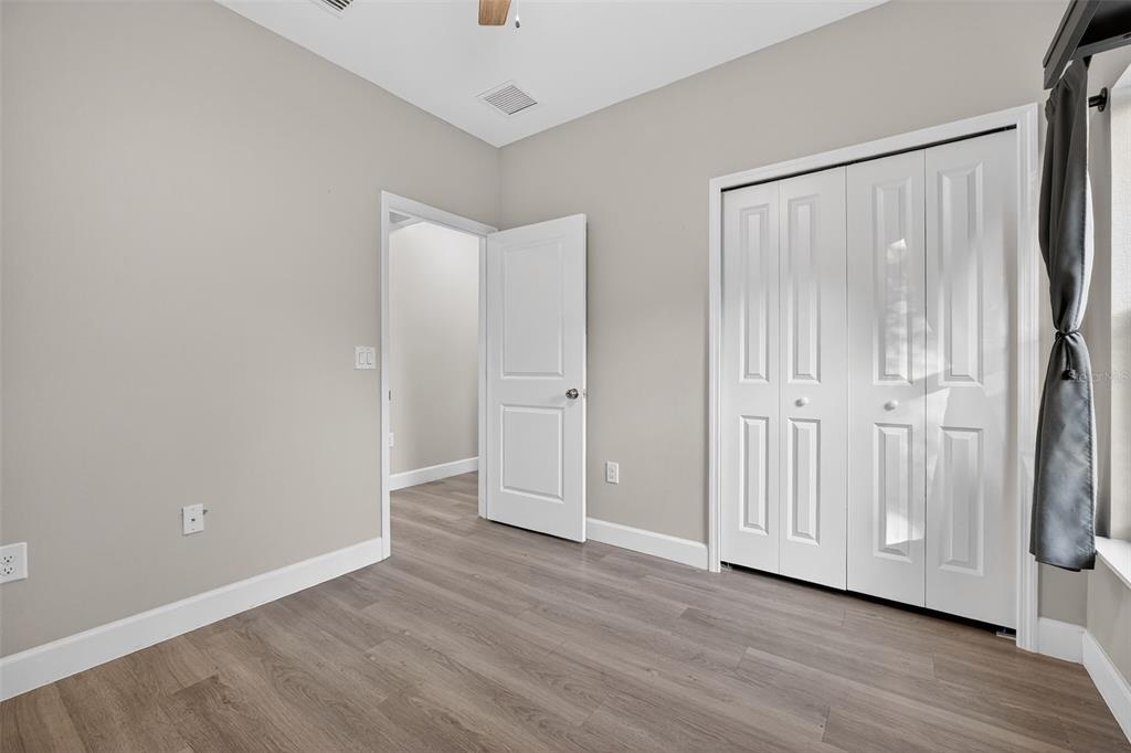 3633 Main Street Sanford, FL 32771 - Photo 17 of 31 a view of an empty room with wooden floor and a window