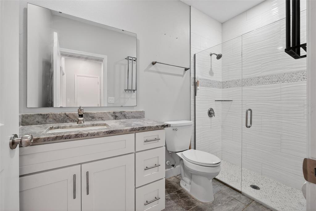 3633 Main Street Sanford, FL 32771 - Photo 18 of 31 a bathroom with a granite countertop sink toilet and shower