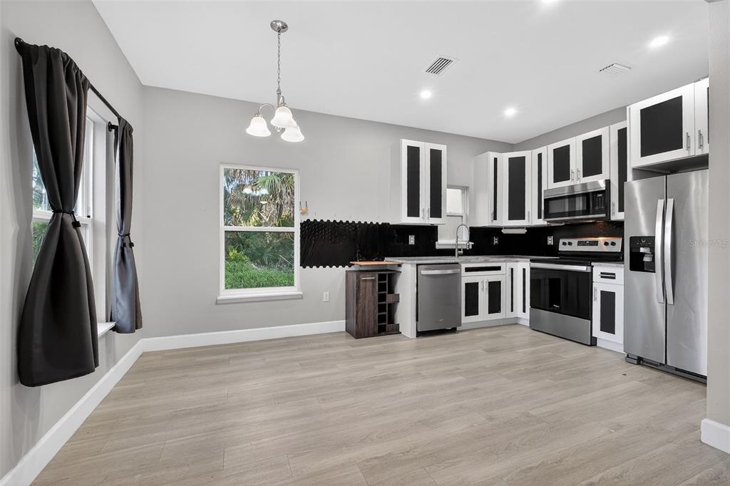 3633 Main Street Sanford, FL 32771 - Photo 6 of 31 a kitchen with stainless steel appliances granite countertop a stove a sink and a refrigerator