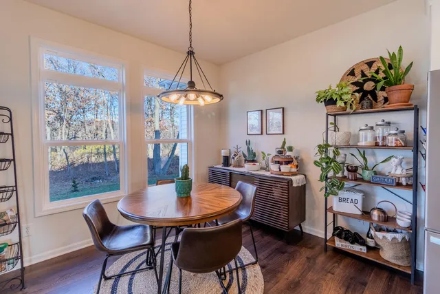 a dining room with furniture and window