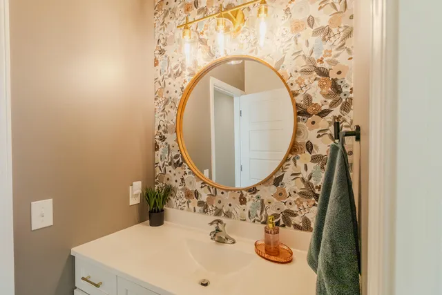 a bathroom with a sink and mirror