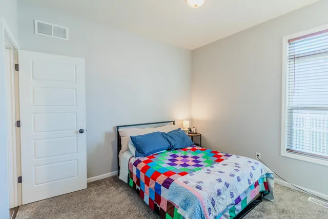 a bedroom with a bed and a window