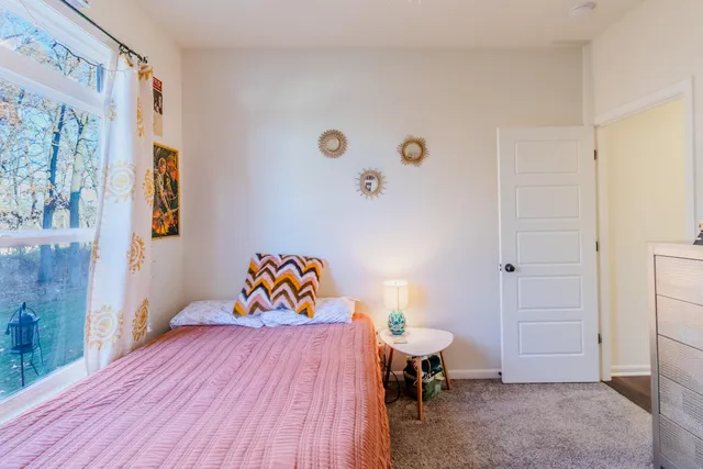 a bedroom with a bed and a table in it