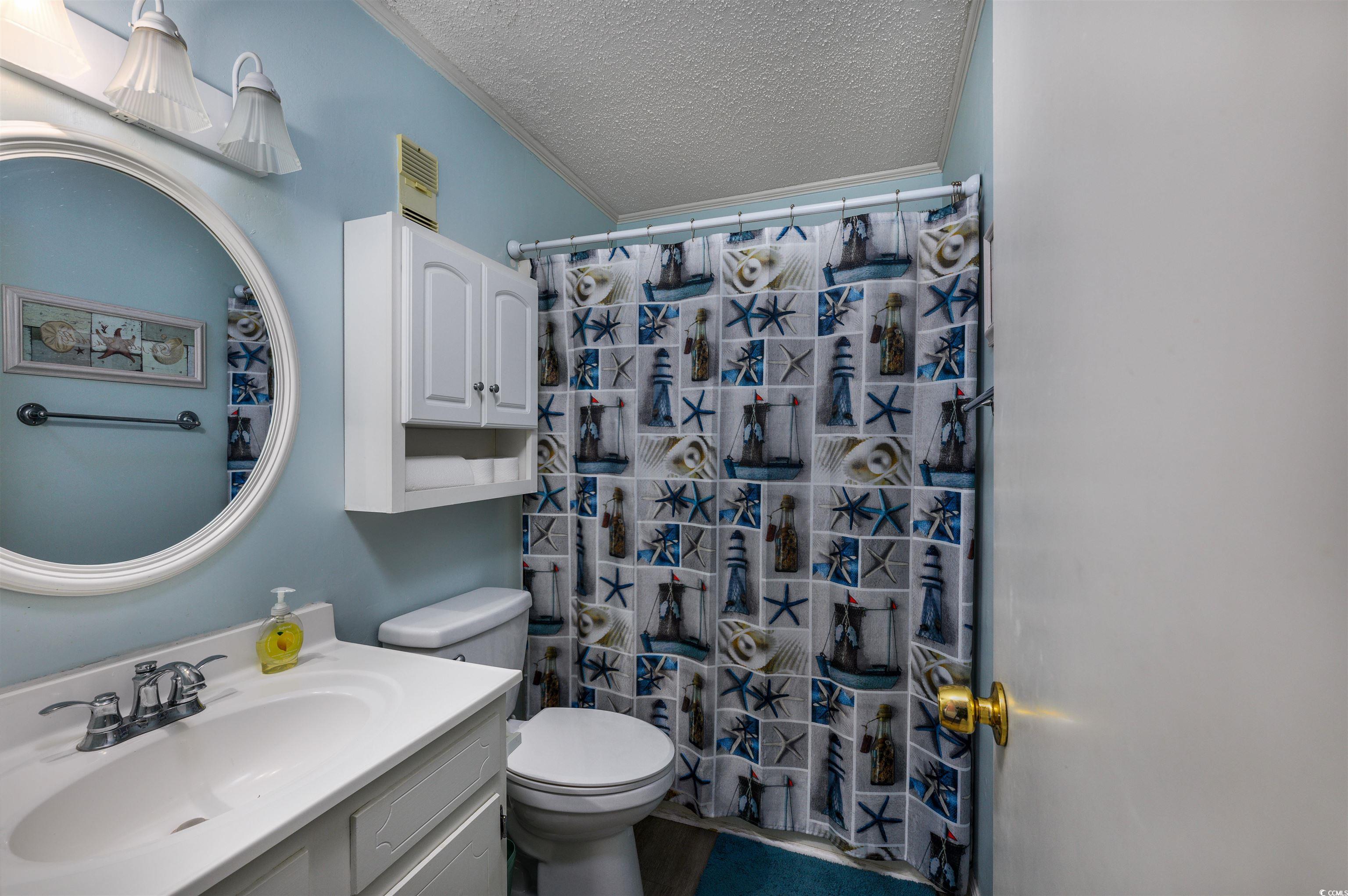 1919 Spring Street, Unit B14 North Myrtle Beach, SC 29582 - Photo 11 of 25 Bathroom featuring a shower with curtain, a textur
