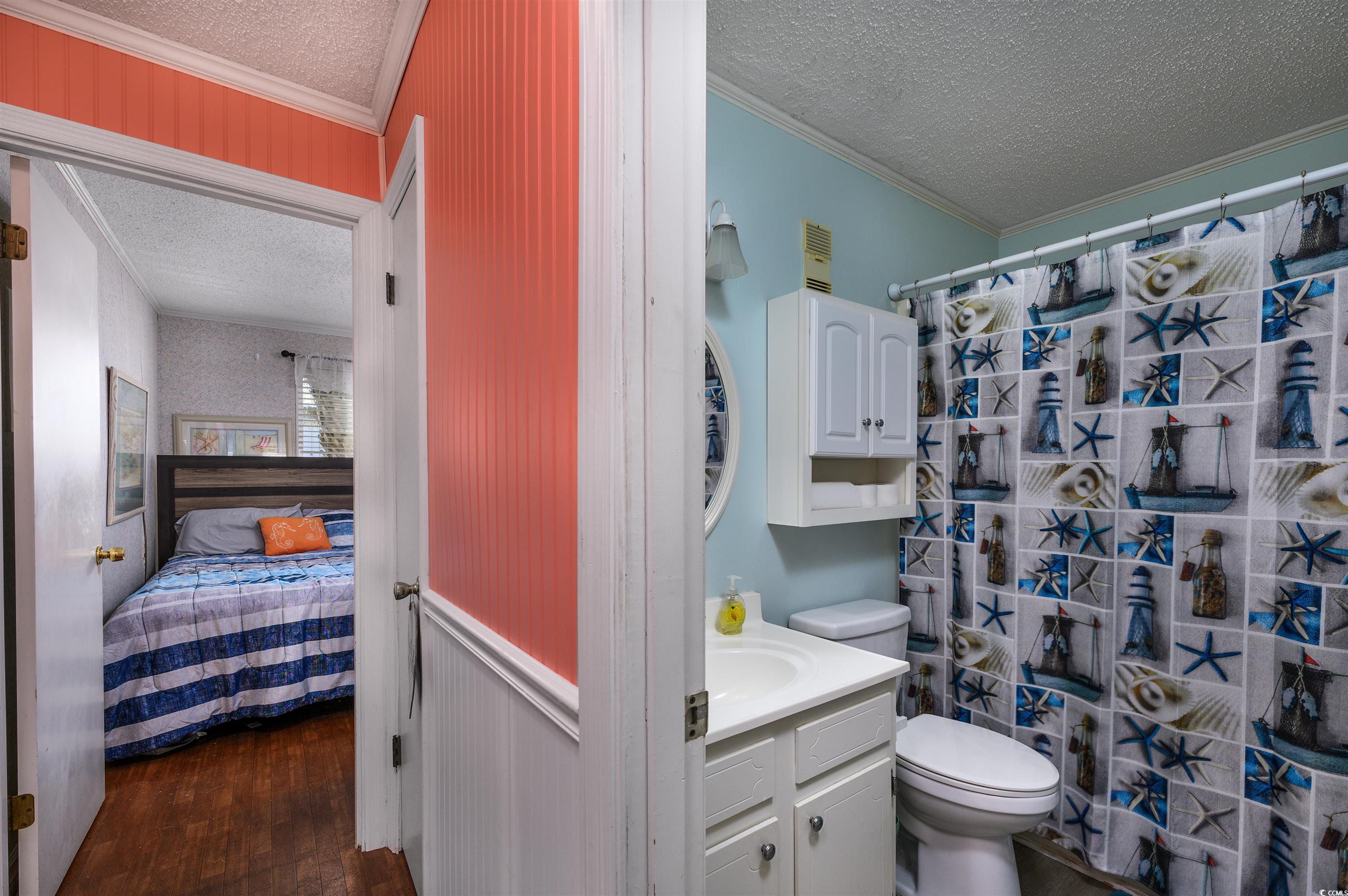1919 Spring Street, Unit B14 North Myrtle Beach, SC 29582 - Photo 12 of 25 Bathroom with vanity, a textured ceiling, hardwood